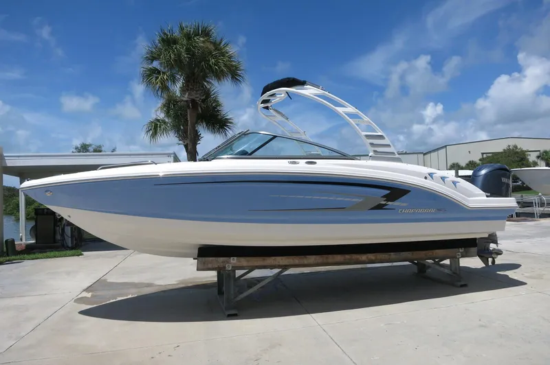 The Image of 2025 Chaparral 23 SSi OB boat on display under a clear blue sky. - 0