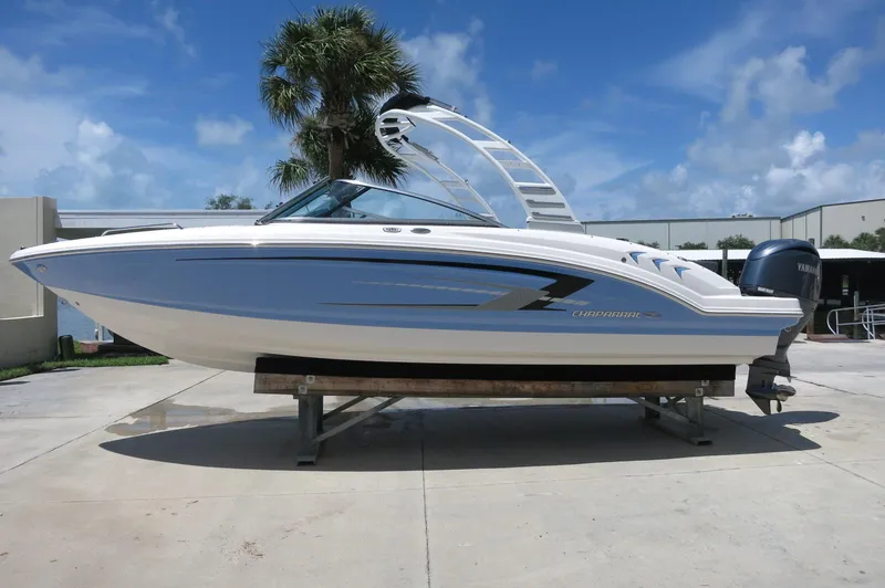 Slide: The Image of 2025 Chaparral 23 SSi OB boat on display, featuring sleek design and Yamaha outboard motor. - 1