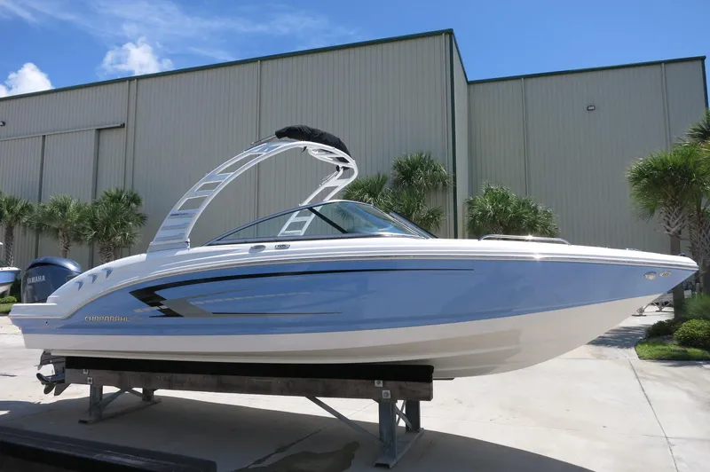 Slide: The Image of 2025 Chaparral 23 SSi OB boat displayed outdoors on a sunny day. - 10