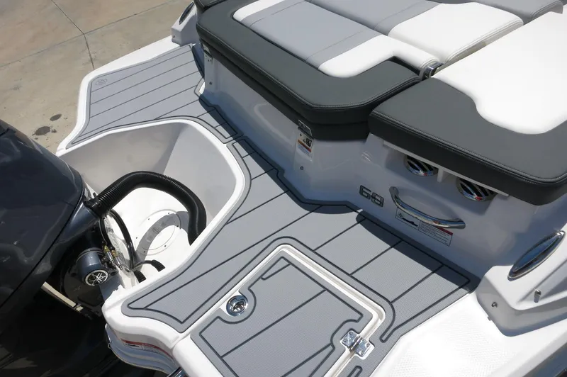 Slide: The Image of 2025 Chaparral 23 SSi OB boat deck with seating and outboard motor. - 12