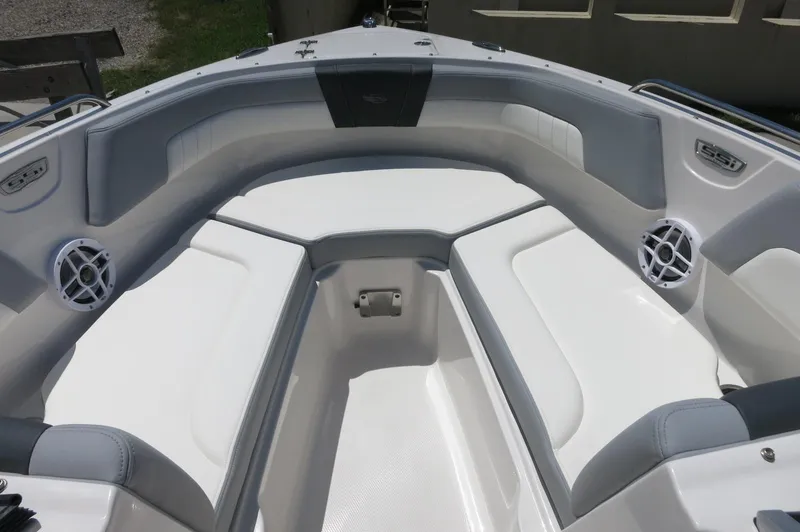 Slide: The Image of 2025 Chaparral 23 SSi OB boat interior with cushioned seating and speakers. - 16