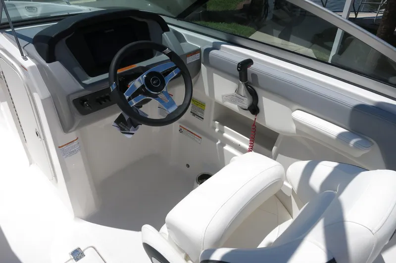 Slide: The Image of 2025 Chaparral 23 SSi OB boat cockpit with steering wheel and controls. - 21