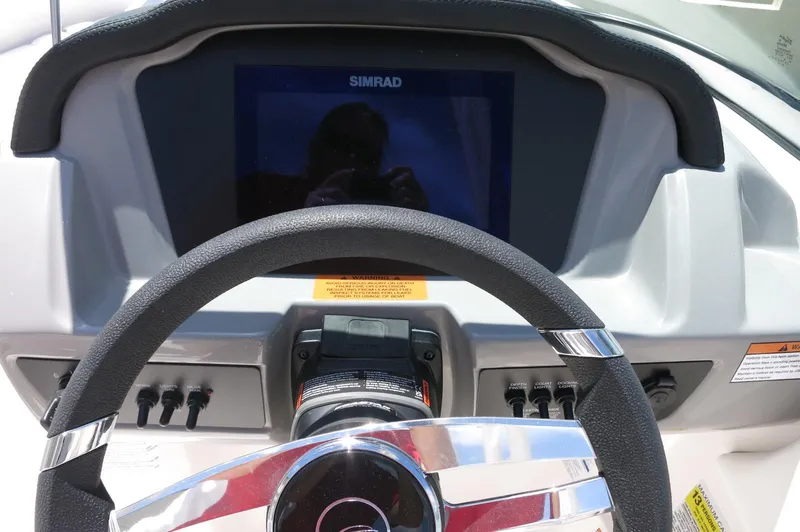 Slide: The Image of Steering wheel and dashboard of 2025 Chaparral 23 SSi OB boat with Simrad display. - 22