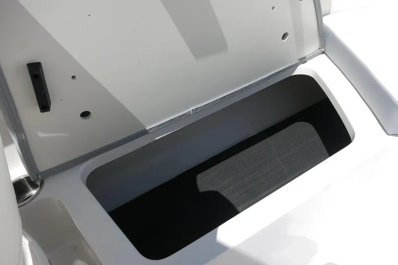 Slide: The Image of Open storage compartment on 2025 Chaparral 23 SSi OB boat. - 30