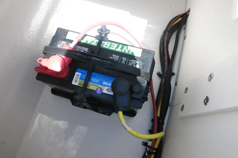 Slide: The Image of Battery compartment of 2025 Chaparral 23 SSi OB boat with wiring and connections. - 33