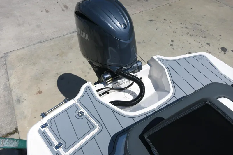 Slide: The Image of 2025 Chaparral 23 SSi OB boat with Yamaha outboard motor, featuring sleek deck design. - 38