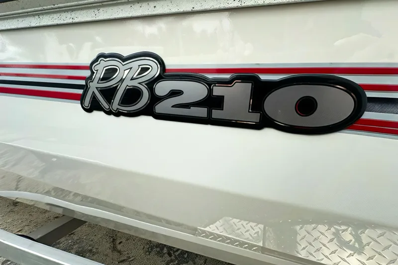 Slide: The Image of 2025 Ranger RB210 boat logo with red and black stripes on white surface. - 12