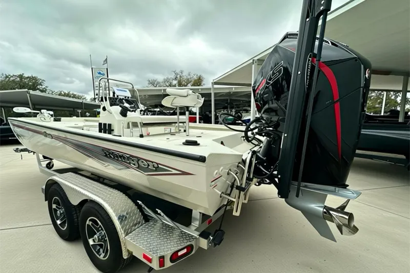 Slide: The Image of 2025 Ranger RB210 boat with powerful outboard motor, parked on a trailer. - 13