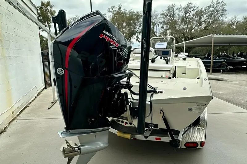 Slide: The Image of 2025 Ranger RB210 boat with Mercury Pro XS engine, parked outdoors. - 17