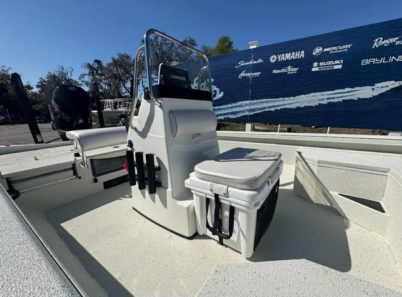 Slide: The Image of 2025 Ranger RB210 boat deck at a marina, showcasing spacious layout and storage compartments. - 2