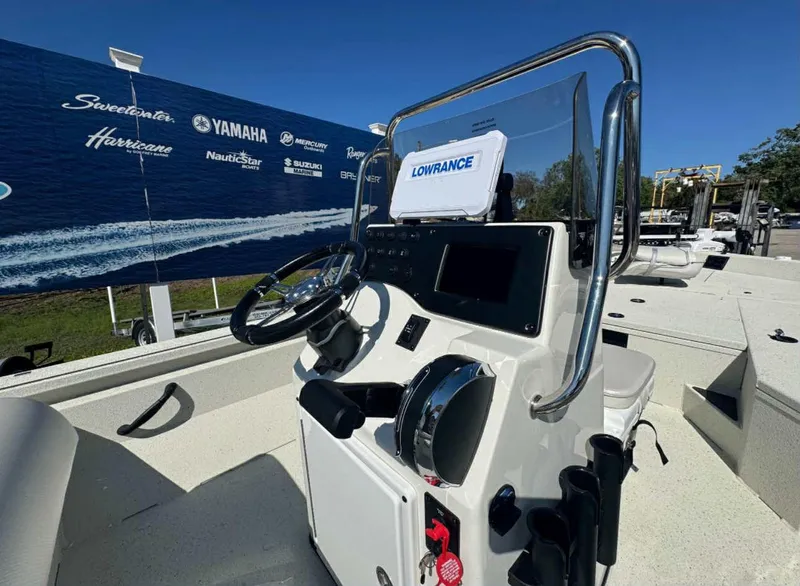 Slide: The Image of 2025 Ranger RB210 boat with Terrova trolling motor, docked under clear blue sky. - 4