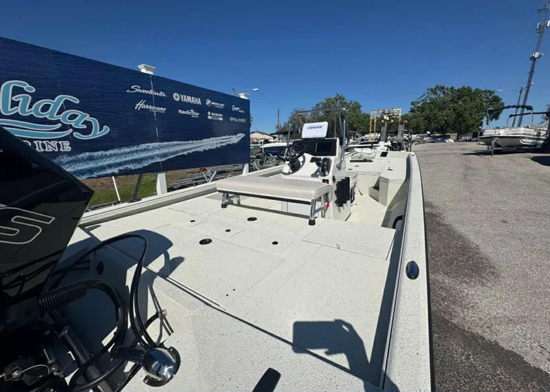 Slide: The Image of 2025 Ranger RB210 boat displayed outdoors at a marina with clear blue sky. - 9