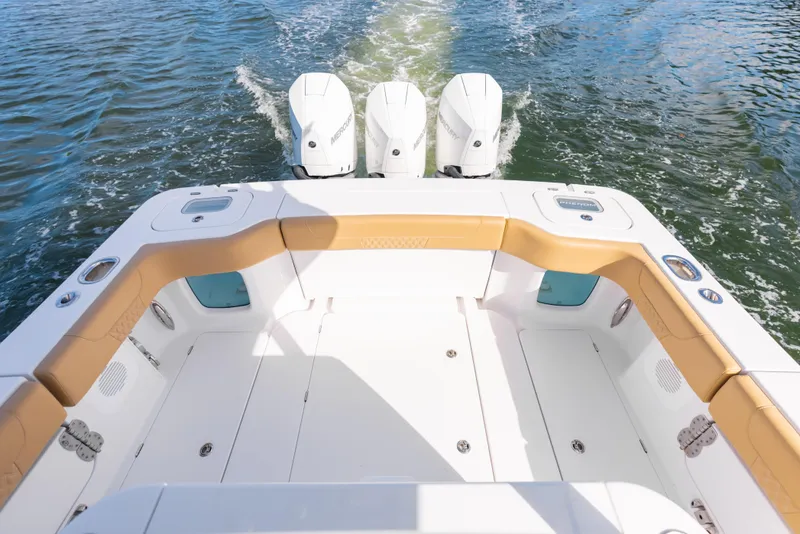 Slide: The Image of 2026 Phenom 34 Center Console boat with triple outboard engines on water. - 13