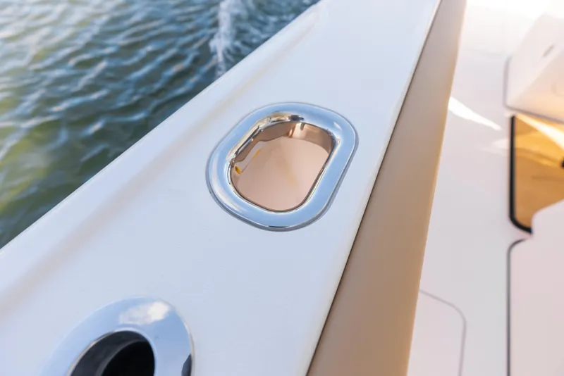 Slide: The Image of Phenom 34 Center Console 2026 boat detail with chrome finish on deck. - 19