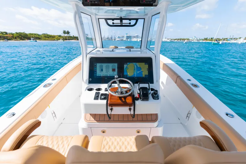 Slide: The Image of 2026 Phenom 34 Center Console boat interior with navigation system on blue ocean. - 2