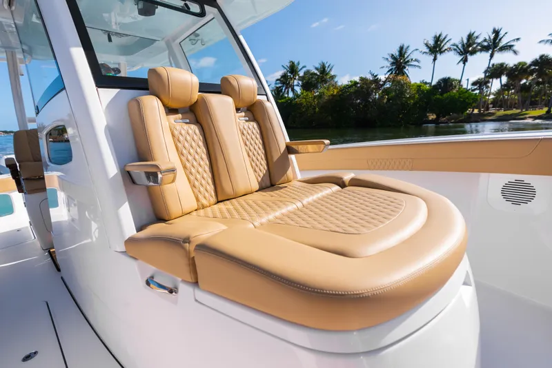 Slide: The Image of Luxurious seating on 2026 Phenom 34 Center Console boat, featuring tan leather upholstery. - 21