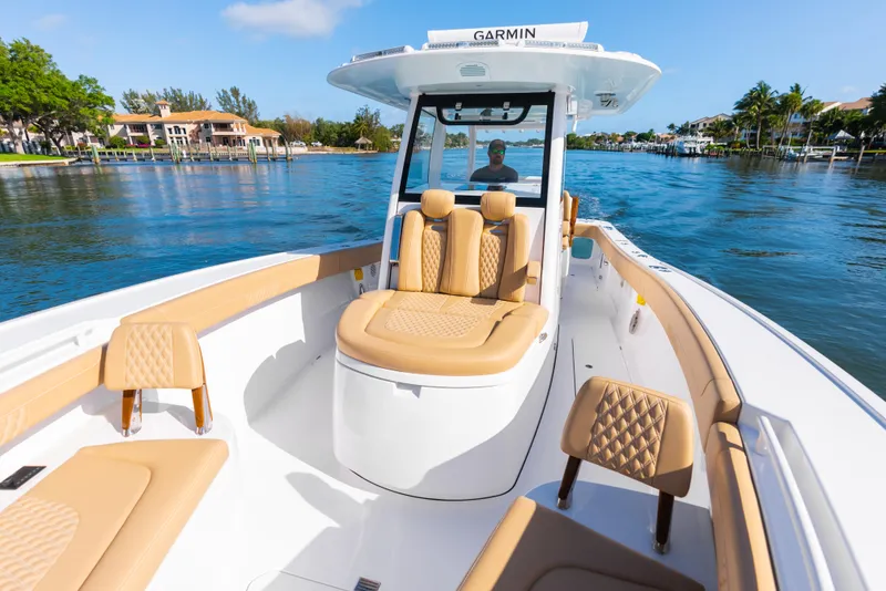 Slide: The Image of 2026 Phenom 34 Center Console boat with tan seating on a sunny day. - 24