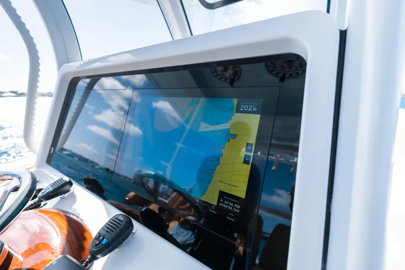 Slide: The Image of 2026 Phenom 34 Center Console with advanced navigation display on the dashboard. - 3