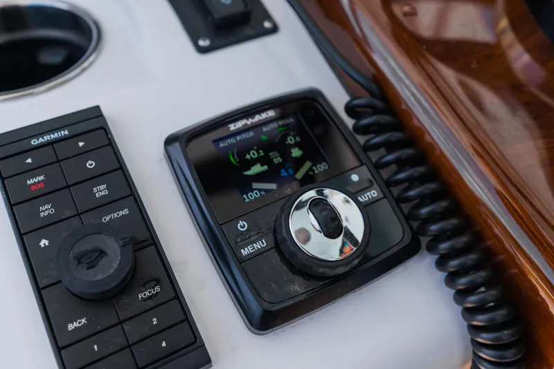 Slide: The Image of Control panel of 2026 Phenom 34 Center Console boat with Garmin and Zipwake systems. - 8