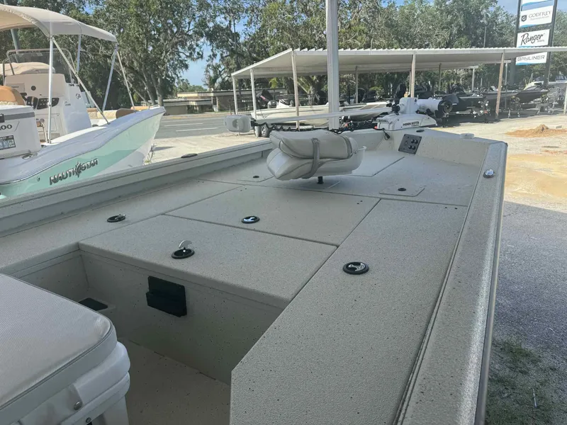Slide: The Image of 2025 Ranger RB200 boat interior with seating and storage, displayed outdoors. - 6