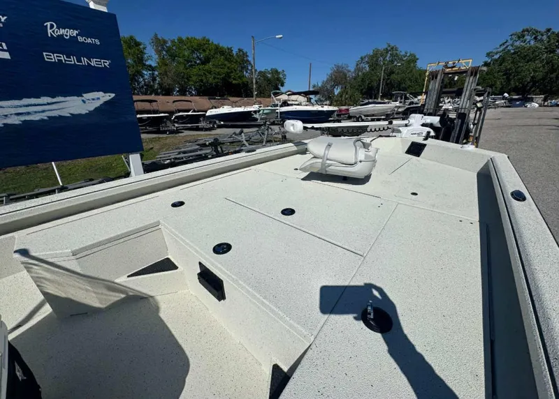 Slide: The Image of 2025 Ranger RB200 boat deck at a marina, featuring storage compartments and seating. - 7
