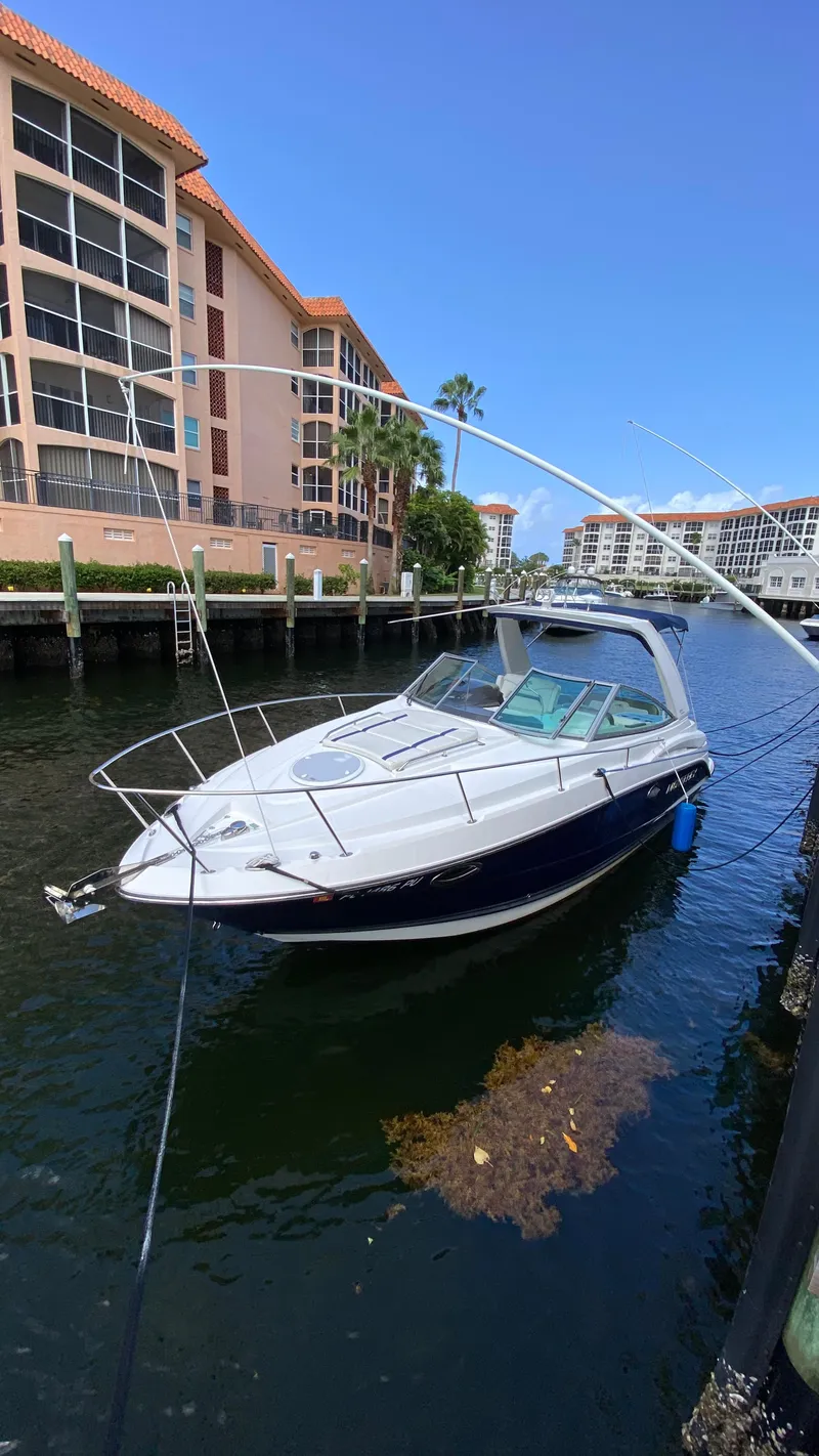 The Image of 2015 Monterey 295 Sport Yacht docked near waterfront apartments. - 0