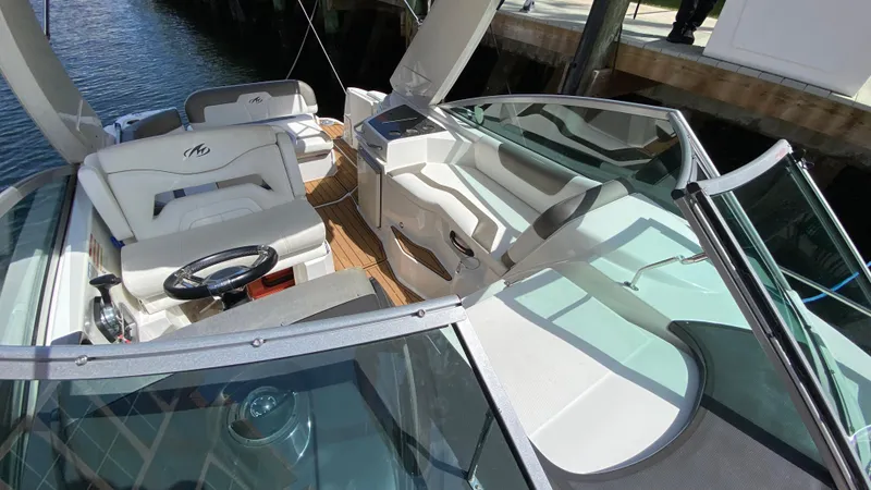 Slide: The Image of 2015 Monterey 295 Sport Yacht interior with white seating and sleek design. - 15