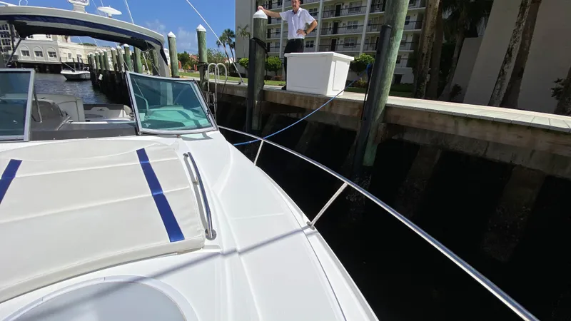 Slide: The Image of 2015 Monterey 295 Sport Yacht docked at marina with person on pier. - 19