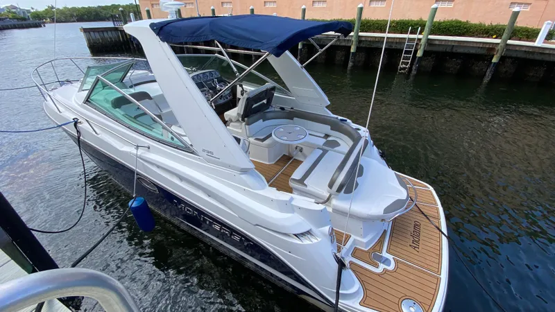 Slide: The Image of 2015 Monterey 295 Sport Yacht docked, featuring sleek design and spacious deck. - 2