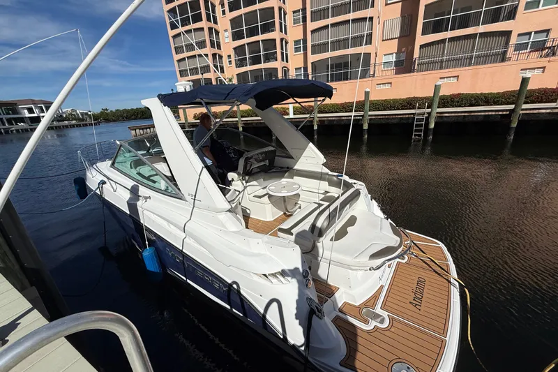 Slide: The Image of 2015 Monterey 295 Sport Yacht docked near waterfront apartments. - 38