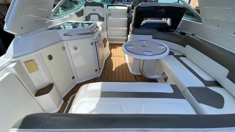 Slide: The Image of Interior of a 2015 Monterey 295 Sport Yacht with seating and table. - 7