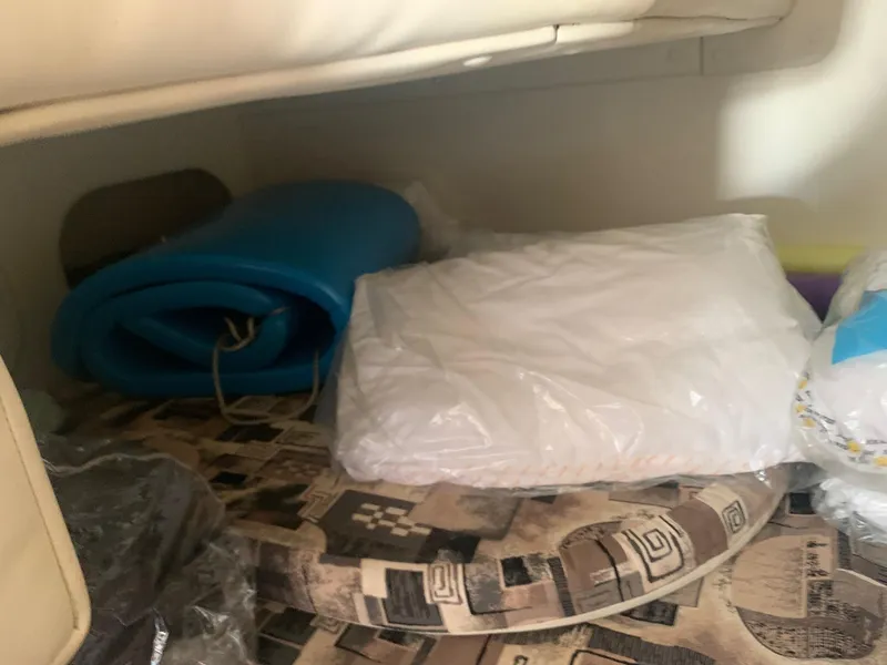 Slide: The Image of Interior of 2003 Rinker FIESTA VEE 270 with cushions and rolled blue mat. - 10