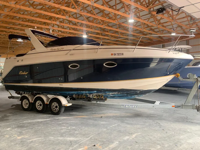 Slide: The Image of 2003 Rinker Fiesta Vee 270 boat on trailer in indoor storage facility. - 2