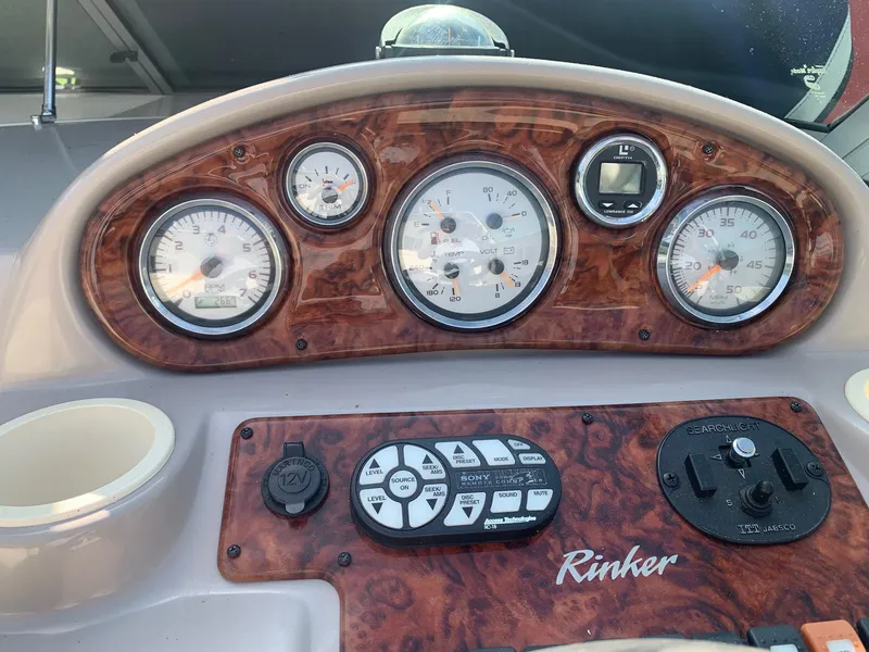 Slide: The Image of Dashboard of a 2003 Rinker FIESTA VEE 270 boat with gauges and controls. - 24