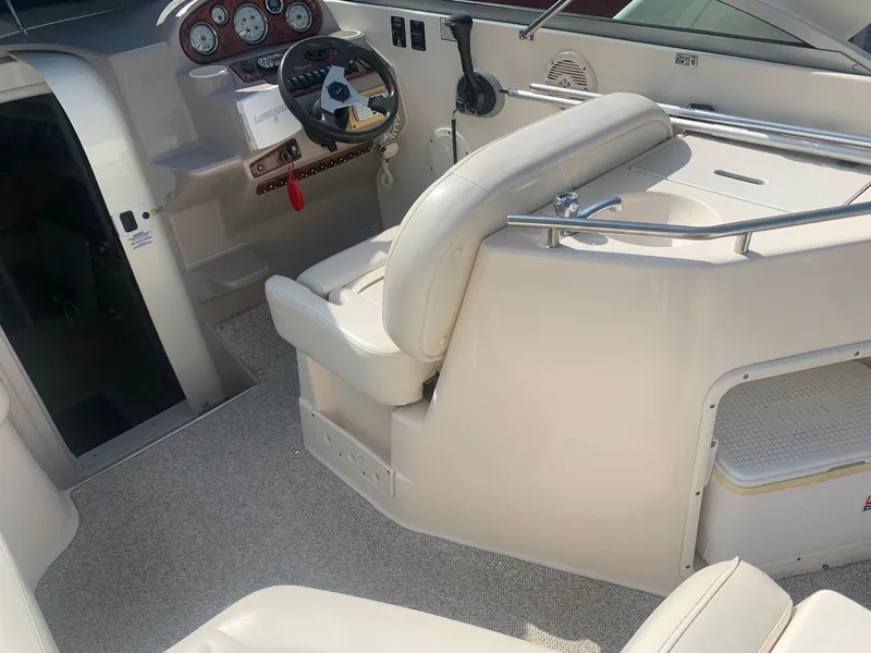 Slide: The Image of 2003 Rinker Fiesta Vee 270 EC boat interior with steering wheel and seating area. - 28