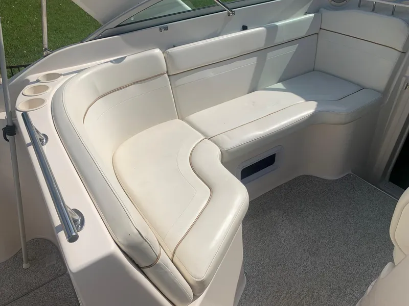 Slide: The Image of 2003 Rinker Fiesta Vee 270 EC boat interior with white cushioned seating. - 29