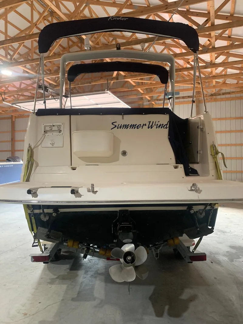 Slide: The Image of 2003 Rinker FIESTA VEE 270 boat named "Summer Wind" in a wooden garage. - 3