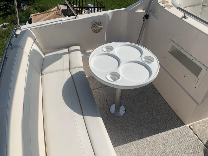 Slide: The Image of 2003 Rinker FIESTA VEE 270 boat interior with seating and round table. - 30