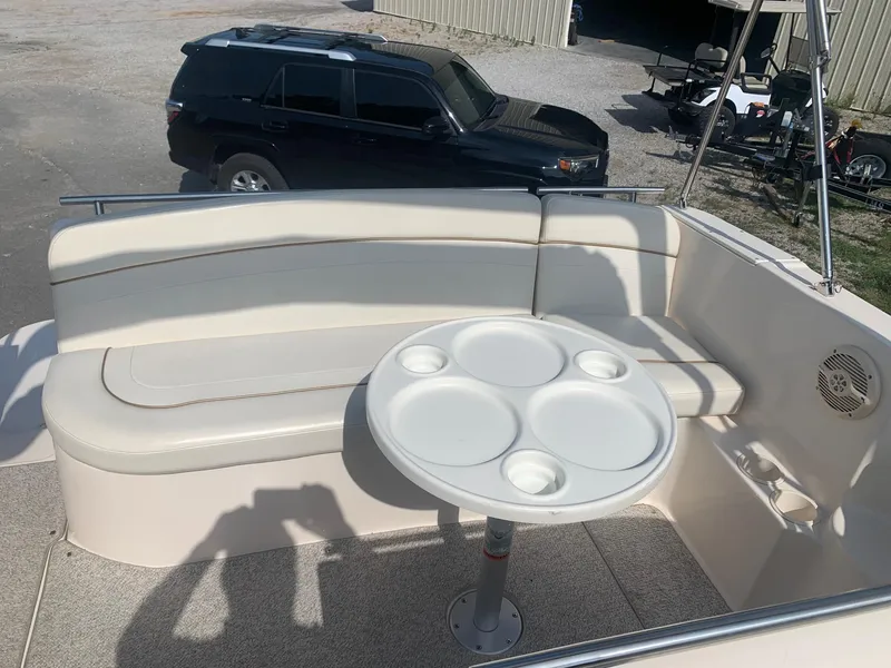 Slide: The Image of 2003 Rinker Fiesta Vee 270 EC boat interior with seating and round table. - 31