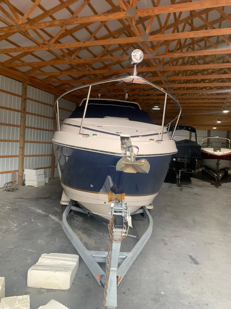 Slide: The Image of 2003 Rinker FIESTA VEE 270 boat stored in a wooden garage. - 4