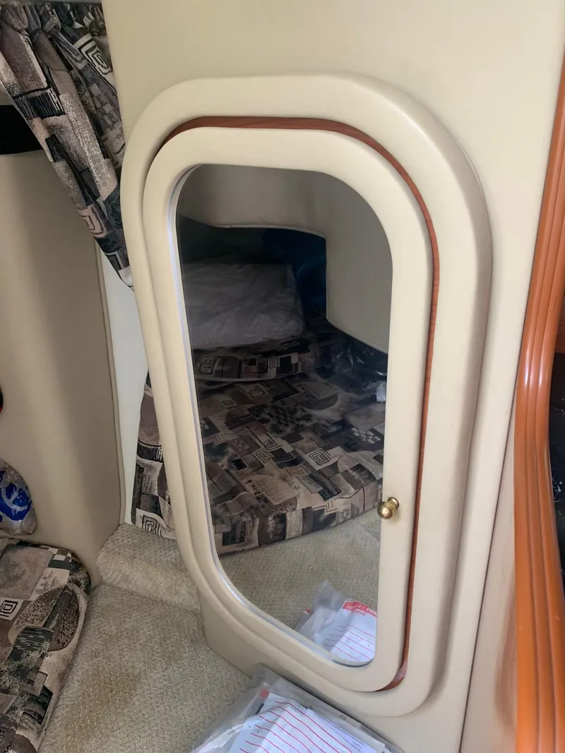 Slide: The Image of Interior cabin of 2003 Rinker FIESTA VEE 270 with mirror and patterned upholstery. - 7