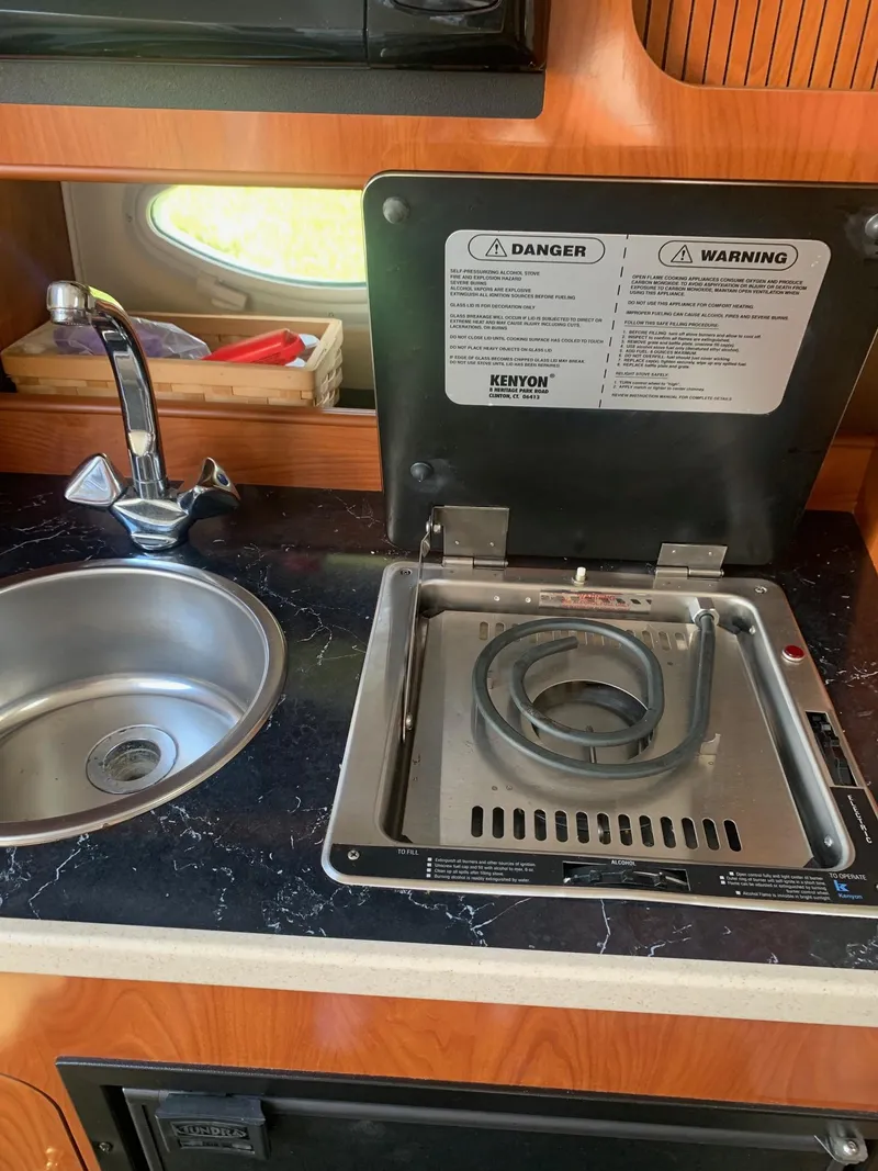 Slide: The Image of 2003 Rinker FIESTA VEE 270 EC boat kitchen with sink and stove. - 8