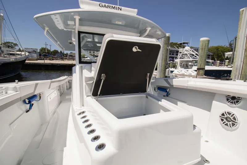 Slide: The Image of 2026 Yellowfin 42 Offshore boat interior with open storage compartment at marina. - 12