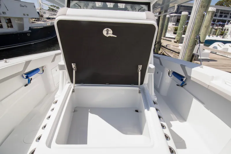 Slide: The Image of 2026 Yellowfin 42 Offshore boat with open storage compartment at dock. - 13