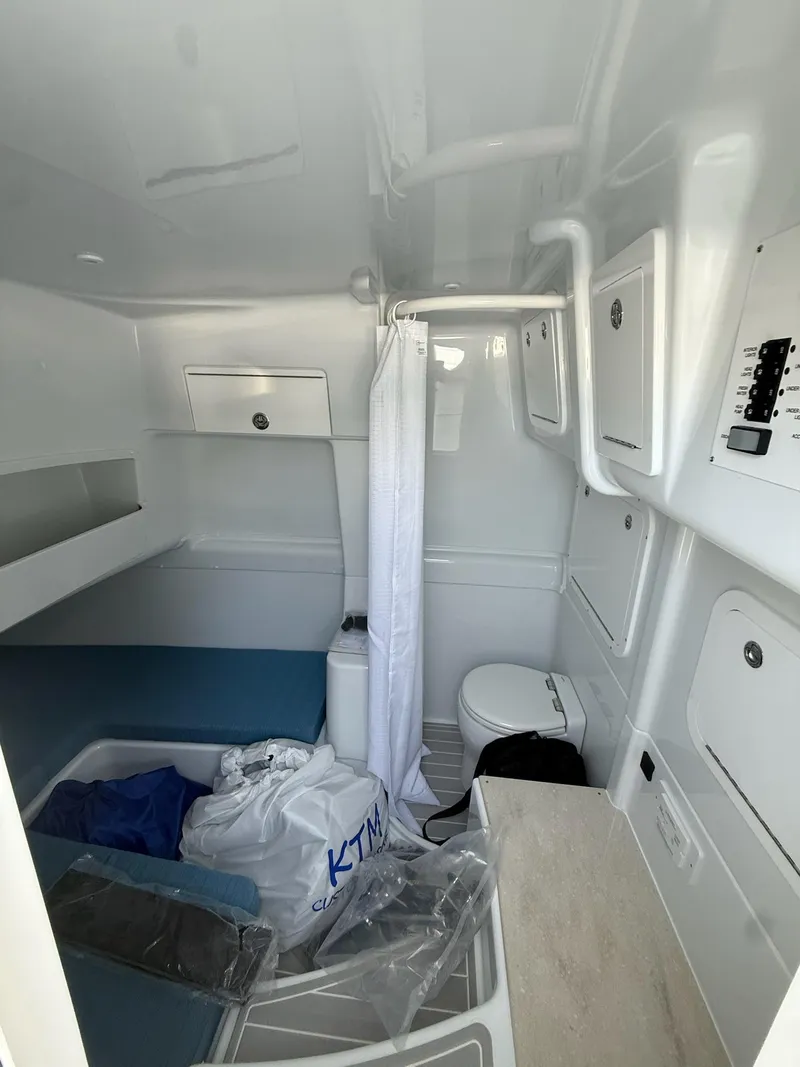 Slide: The Image of 2026 Yellowfin 42 Offshore cabin interior with bed, toilet, and storage compartments. - 16