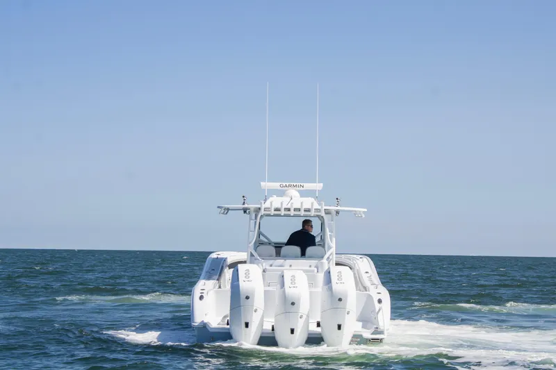 Slide: The Image of 2026 Yellowfin 42 Offshore boat cruising on open sea with multiple engines. - 2