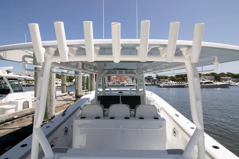 Slide: The Image of 2026 Yellowfin 42 Offshore boat docked at marina, showcasing spacious seating and rod holders. - 20