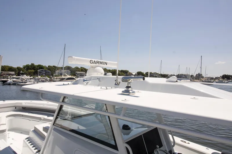 Slide: The Image of 2026 Yellowfin 42 Offshore boat with Garmin radar, docked in a marina. - 21