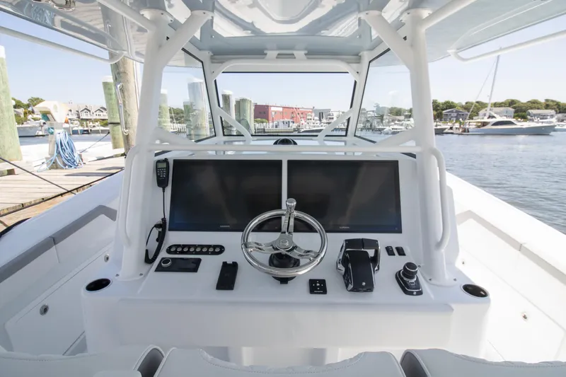 Slide: The Image of 2026 Yellowfin 42 Offshore boat helm with dual screens and steering wheel. - 26