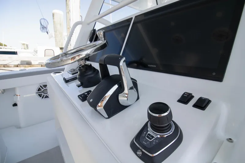Slide: The Image of Control panel of 2026 Yellowfin 42 Offshore boat with steering wheel and navigation screens. - 28